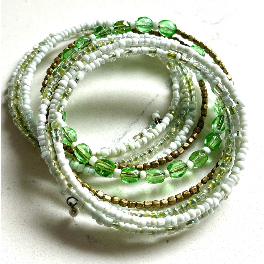 Assorted beads and glass bracelet. One full “slinky-like” piece ! Fits 7” wrist